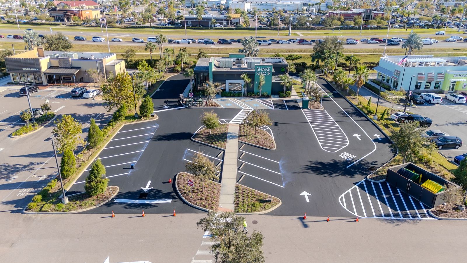 Aerial view of a freshly paved and striped Tampa commercial parking lot