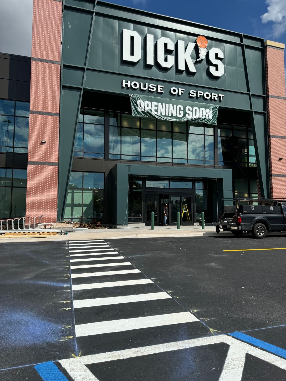 Freshly striped crosswalk and ADA access aisle at a Tampa retail storefront